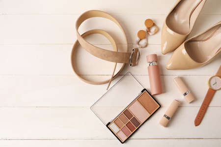 Set of female accessories and cosmetics on light wooden backgroundの写真素材