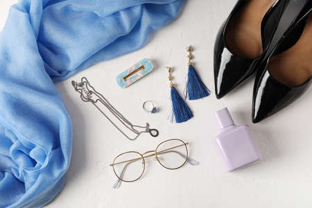 Set of female accessories with stylish shoes on light background