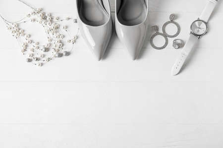 Set of female accessories and stylish shoes on light wooden backgroundの写真素材