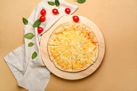Board with tasty cheese pizza on color background