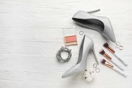 Set of female accessories with stylish shoes on light wooden backgroundの写真素材