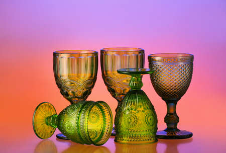 Beautiful empty glasses on color backgroundの写真素材