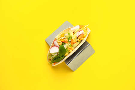 Stand with tasty vegetarian taco on color backgroundの写真素材