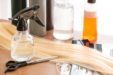 Barber set with strand of hair on table, closeup