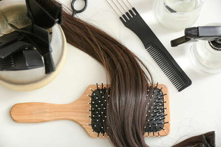 Barber set with strand of brunette hair on table