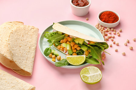 Plate with tasty vegetarian taco and sauce on color backgroundの写真素材