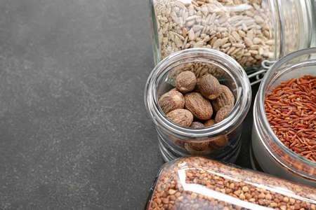 Glass jars with different products on dark backgroundの写真素材