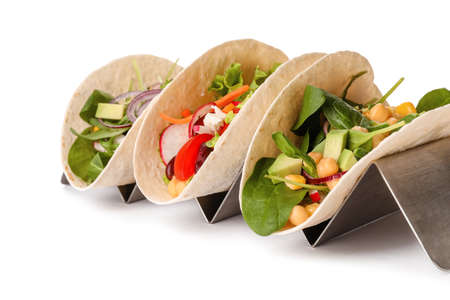Stand with tasty vegetarian tacos on white backgroundの写真素材