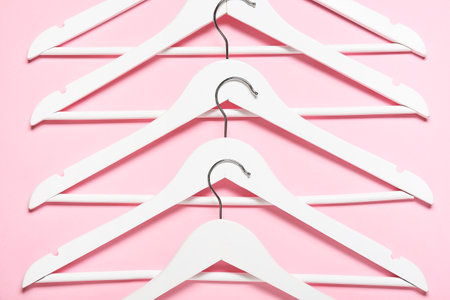 Stylish clothes hangers on color backgroundの写真素材