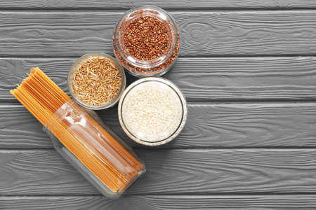 Glass jars with different products on dark wooden backgroundの写真素材