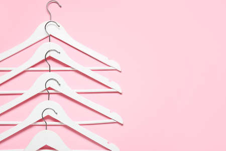 Stylish clothes hangers on color backgroundの写真素材