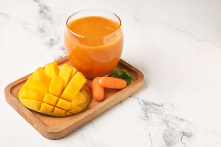 Glass of healthy smoothie and ingredients on light backgroundの写真素材