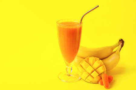 Glass of healthy smoothie and ingredients on color backgroundの写真素材