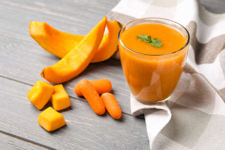 Glass of healthy smoothie with vegetables on wooden backgroundの写真素材