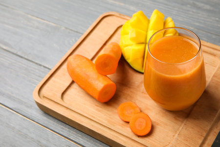 Glass of healthy smoothie and ingredients on wooden backgroundの写真素材