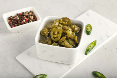 Bowl with canned jalapeno on light backgroundの写真素材