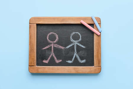 Chalkboard with drawn human figures on color backgroundの写真素材