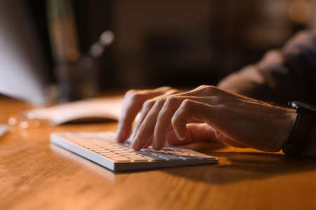 Businessman working in office late at night, closeup
