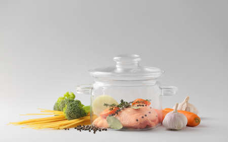 Stylish cooking pot and products on light backgroundの写真素材