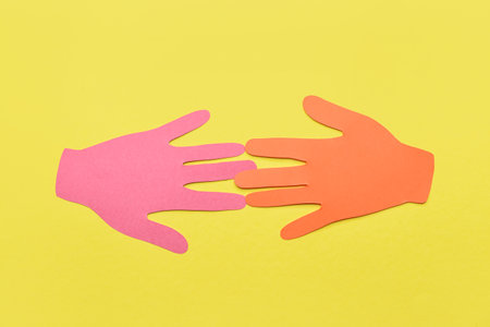 Paper human palms on color backgroundの写真素材