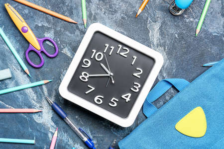 Composition with stylish clock and stationery on color backgroundの写真素材
