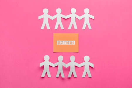 Paper human figures and greeting card for Friendship Day on color backgroundの写真素材