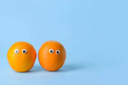 Funny orange fruit on color backgroundの写真素材