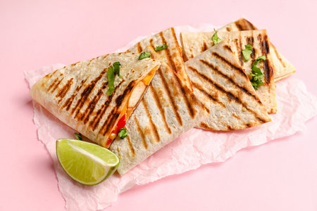 Parchment with tasty quesadillas and lime on color backgroundの写真素材