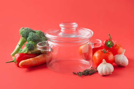 Stylish cooking pot and products on color backgroundの写真素材