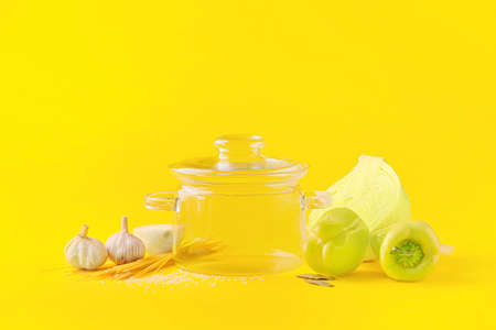 Stylish cooking pot and products on color backgroundの写真素材