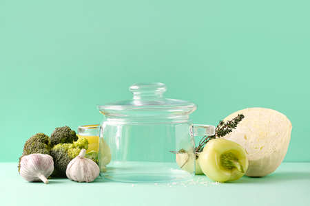 Stylish cooking pot and products on color backgroundの写真素材