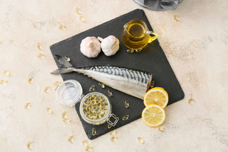 Composition with fish oil pills on grunge backgroundの写真素材