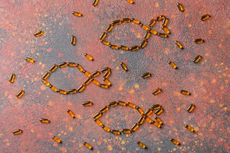 Composition with fish oil pills on grunge background