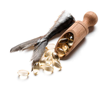 Fish with oil pills and tail of a mackerel on white background