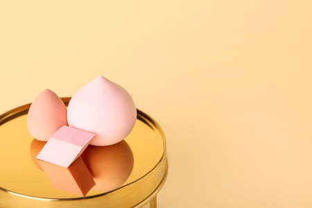Makeup sponges and decor on color backgroundの写真素材