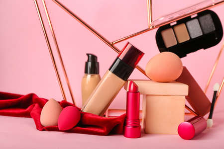 Makeup sponges and decorative cosmetics on color backgroundの写真素材