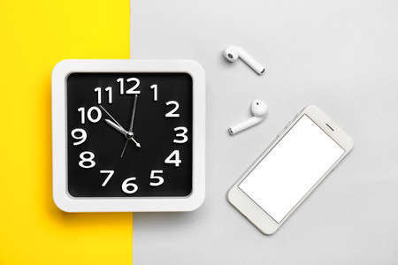 Composition with stylish clock and gadgets on color backgroundの写真素材