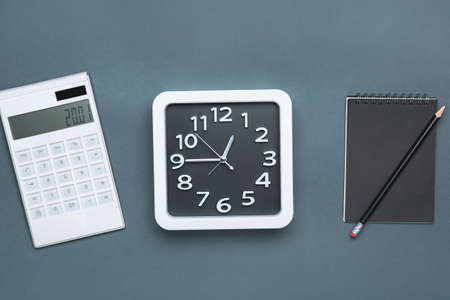 Composition with stylish clock and calculator on gray backgroundの写真素材