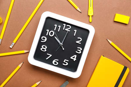 Composition with stylish clock and stationery on color backgroundの写真素材