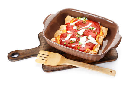 Baking dish with tasty cooked enchilada on white backgroundの写真素材