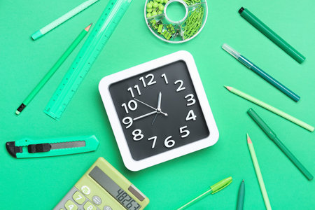 Composition with stylish clock and stationery on color backgroundの写真素材