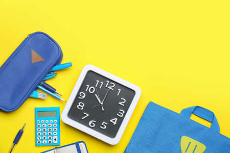 Composition with stylish clock and stationery on color backgroundの写真素材
