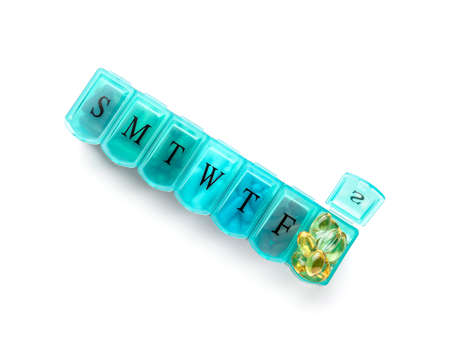 Container with fish oil capsules on white background