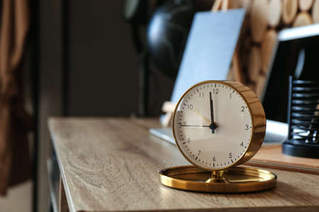 Stylish alarm clock on table in roomの写真素材