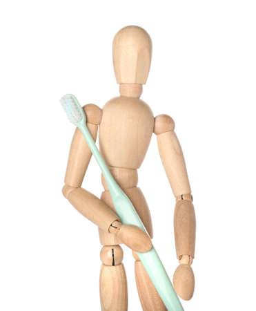 Wooden mannequin with toothbrush on white backgroundの写真素材