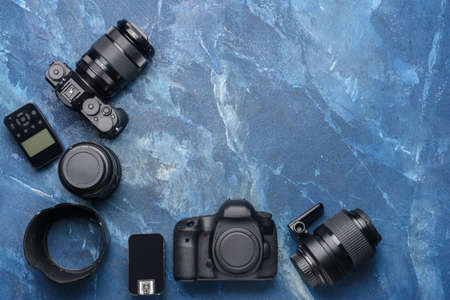 Modern photographer's equipment on color backgroundの写真素材