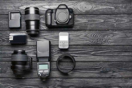 Modern photographer's equipment on dark wooden backgroundの写真素材