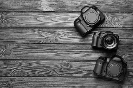 Digital cameras on dark wooden backgroundの写真素材