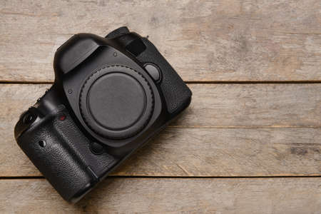 Digital camera on wooden background
