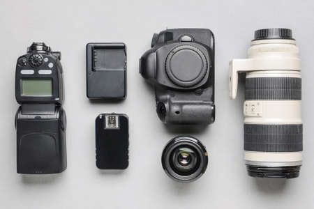 Modern photographer's equipment on light background
